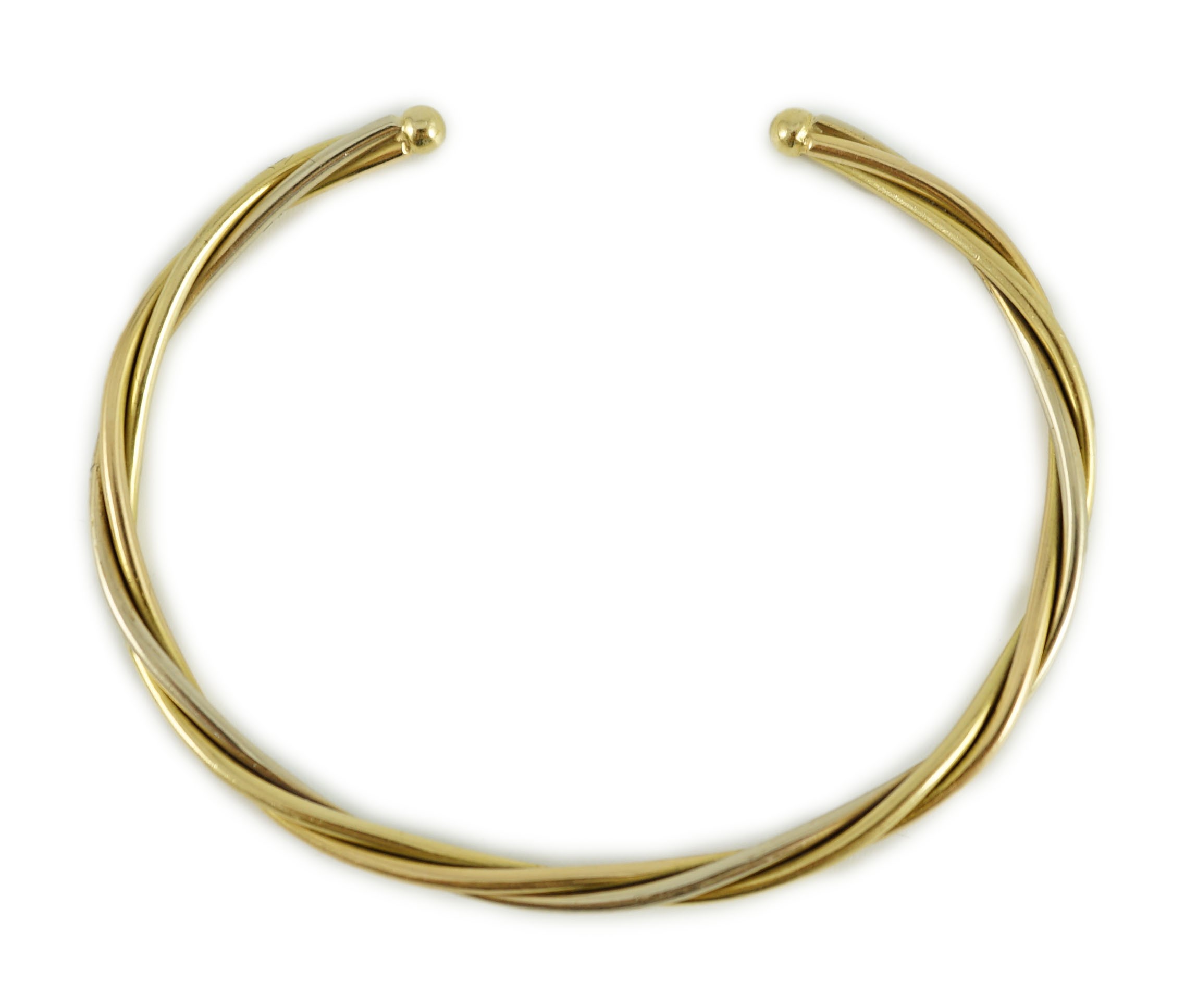A modern Cartier 18k gold spiral twist open work bangle